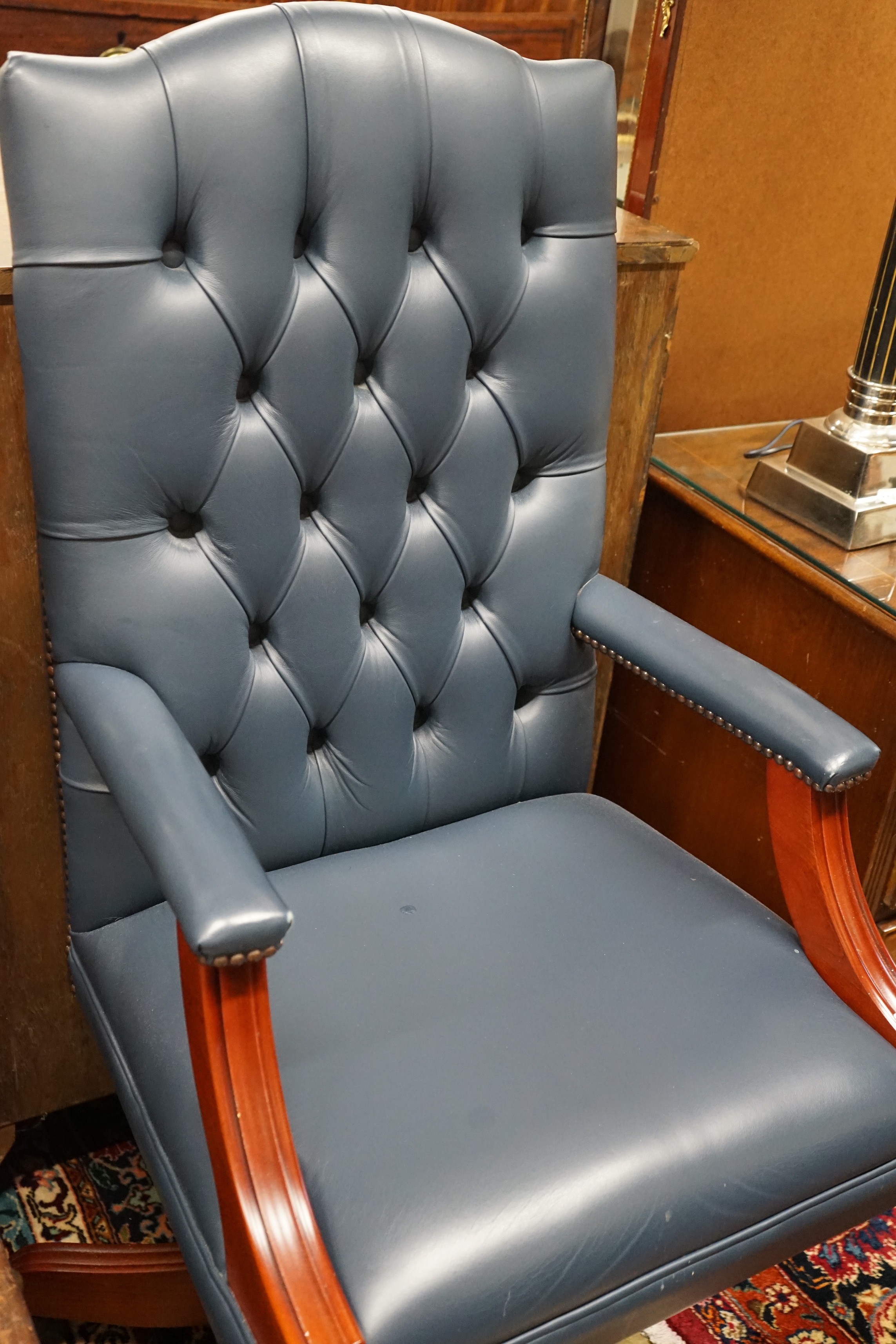 A Regency style mahogany blue buttoned leather swivel desk chair, width 58cm, depth 55cm, height 112cm